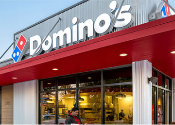 a man standing in front of a restaurant